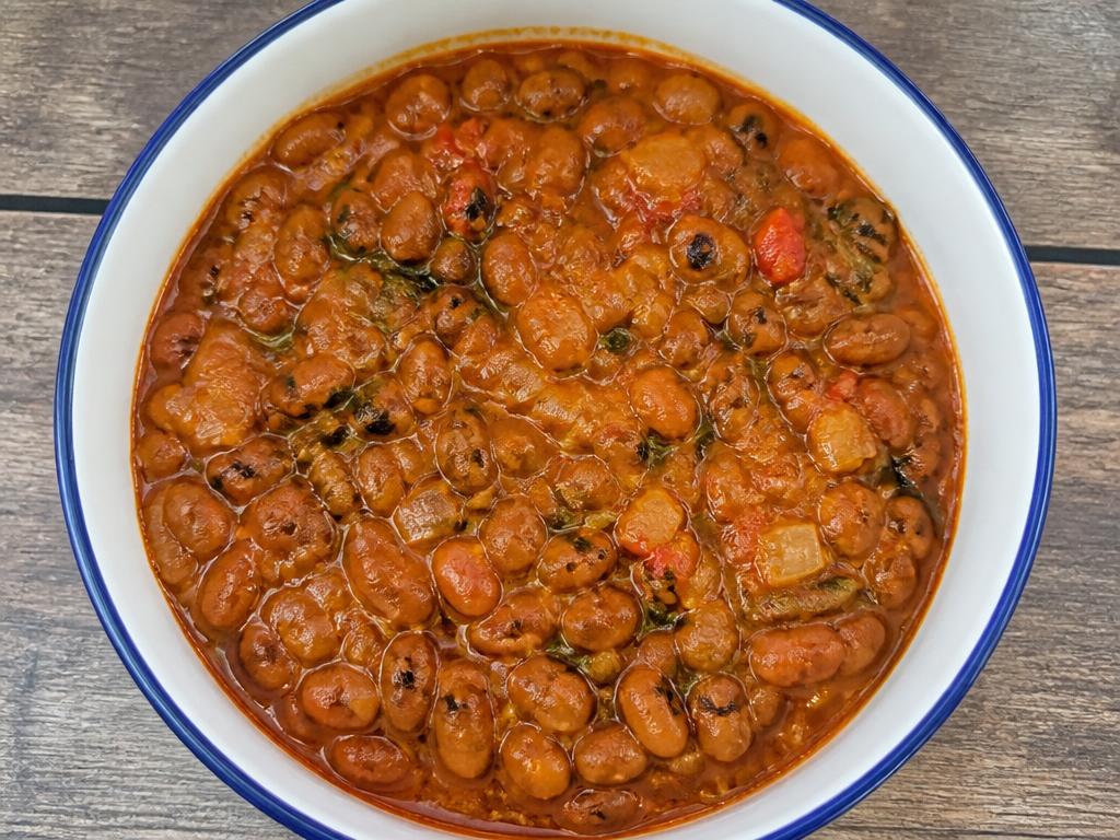 Bowl of Nigerian beans porridge with vegetables
