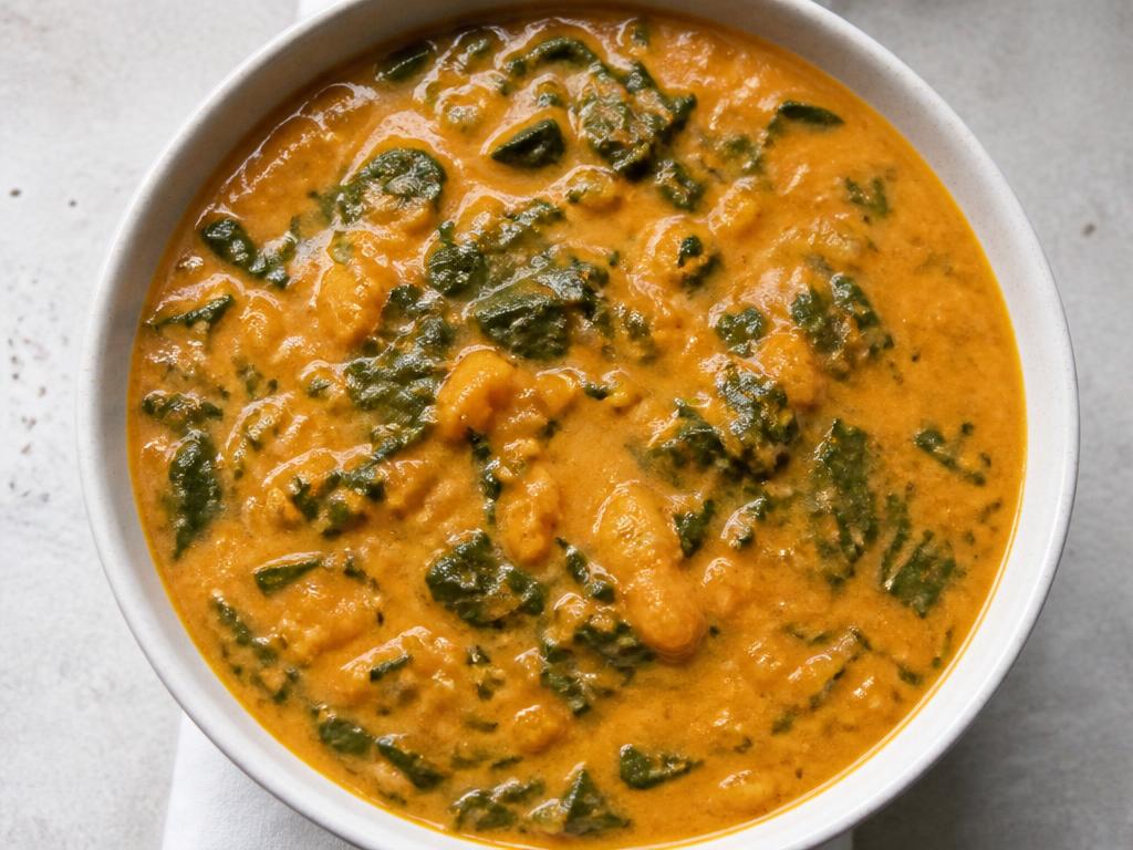 Bowl of Nigerian sweet potato and ugu leaf soup